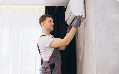 Technician installing air conditioning unit